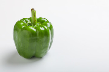 fresh green bell pepper (capsicum) on a white background