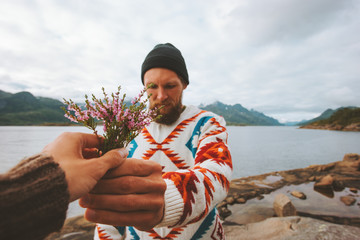 Man giving flowers bouquet couple in love romance lifestyle honeymoon vacations relationship authentic feelings travel outdoor together