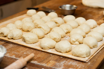 Fototapeta na wymiar dough pieces lies on a wooden table.