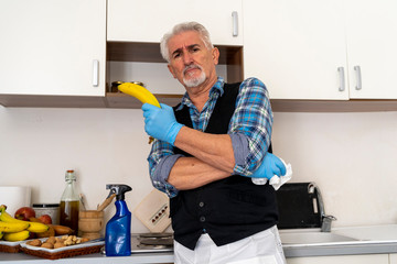 mature single man is doing housework during tough quarantine