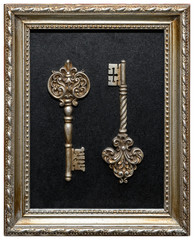 Two decorative vintage keys on a black background in a wooden frame