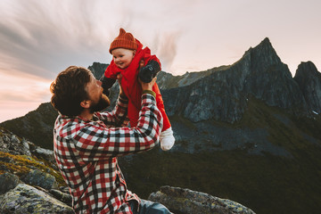 Father holding up baby happy family travel vacations hiking in mountains man with child together...