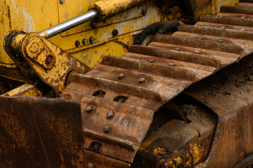 Old yellow bulldozer caterpillar tracks example