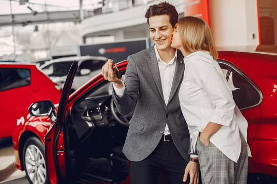 Couple buying the car. Pair in a car salon. Husband with vife choose the automobile