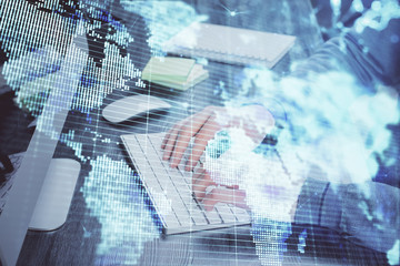 Double exposure of businessman working on laptop on background. International business hologram in front. Concept of success.