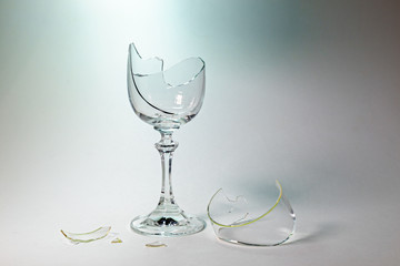 A broken goblet glass on a white background.