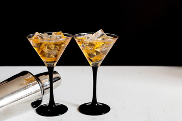 two cocktails glasses and cocktail shaker