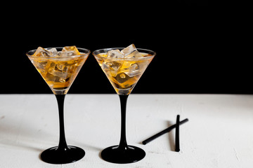 two cocktails glasses and straws