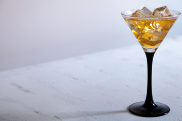 cocktail glass with ice cube
