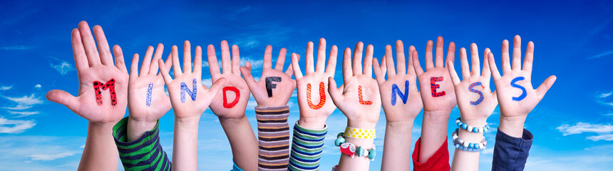 Children Hands Building Colorful English Word Mindfulness. Blue Sky As Background