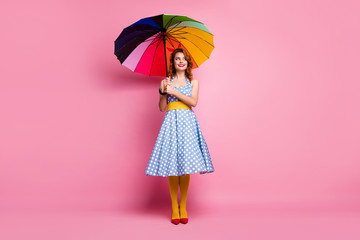 Full length photo of cheerful fancy lady hold bright umbrella look copyspace enjoy rainy day weekend wear yellow blue headband red shoes tights isolated over pink color background © deagreez