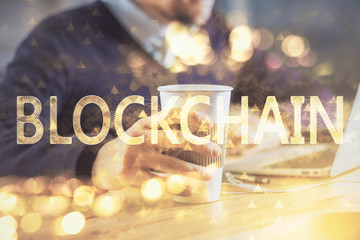 Crypto currency theme hologram with businessman working on computer on background. Concept of...