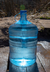 A nineteen-liter water bottle on a wooden walkway
