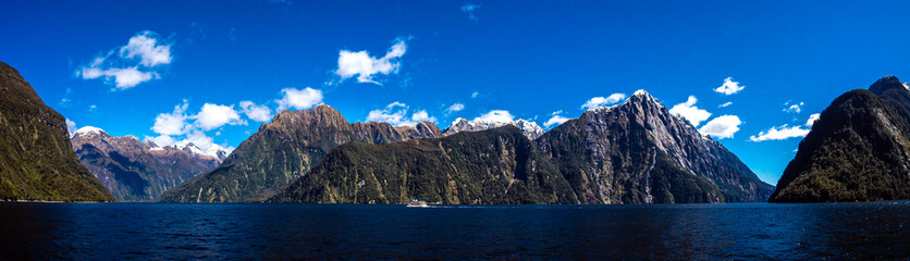 Beautiful panorama of Milford Sound with Mitre Peak on the foreground and snow capped mountains in...
