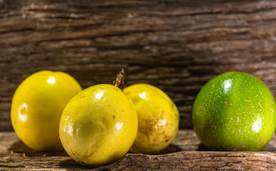 Yellow and ripe passion fruit on aged wooden background