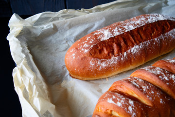 Fresh baked bread on a black background.