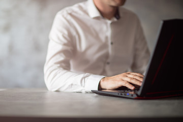 Bizmemen w białej koszuli pisze na komputerze