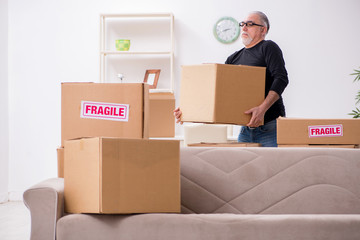 Fototapeta premium Old male professional mover doing home relocation