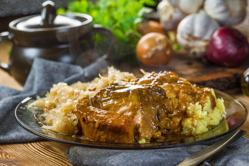 Fried ribs in sauerkraut served with boiled potatoes.