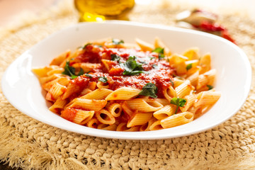Penne pasta with tomato sauce. Traditional Italian dish, pasta with chili sauce. Italian food.