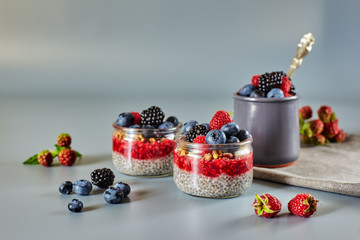 Vegan healthy food. Chia pudding with fresh raspberries, blueberries, blackberries and granola or musley.