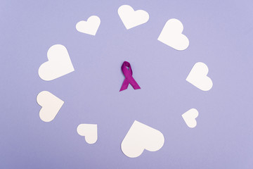 High angle view of purple ribbon in frame of paper hearts isolated on purple