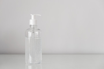 Plastic bottle pump with alcohol gel on the table with copy space. For cleaning hand and clear bacteria for stop corona virus outbreak. Protection against the virus, Covid 19, coronavirus 2019.