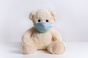 Teddy bear with protective medical mask on his face. Concept of hygiene and virus protection for child patient