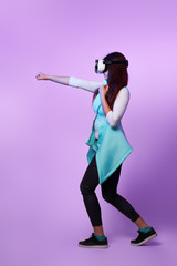 Fototapeta premium Woman is using virtual reality headset, playing game and fighting.