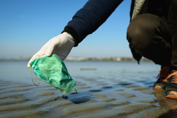 Dirty used medical mask on beach