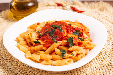 Penne pasta with tomato sauce. Traditional Italian dish, pasta with chili sauce. Italian food.