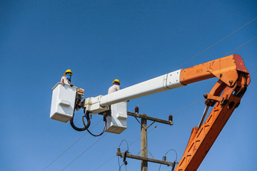 maintenance of electricians work with high voltage electricity on the hydraulic bucket