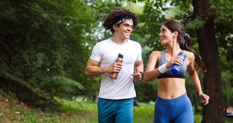 Happy couple running and exercising together outdoor