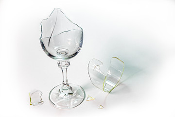 A broken goblet glass on a white background.