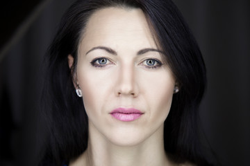 A portrait of a beautiful young female with perfect skin. She is looking straight at the camera...