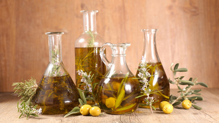 assorted of olive oil in bottle with branch, rosemary