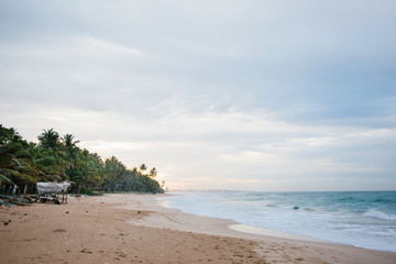 The coast of the Indian Ocean at dawn in Sri Lanka in March 2020. Calm beautiful water and azure blue waves