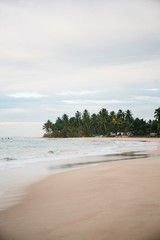 The coast of the Indian Ocean at dawn in Sri Lanka in March 2020. Calm beautiful water and azure blue waves