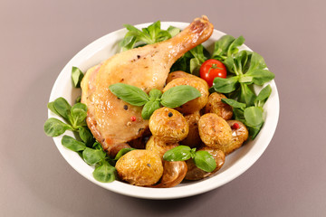 grilled chicken leg with potato and lettuce