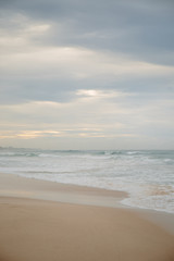 The coast of the Indian Ocean at dawn in Sri Lanka in March 2020. Calm beautiful water and azure blue waves