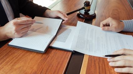 Male Notary lawyer or judge consult or discussing contract papers with Businessman client in office, Law and Legal services concept.