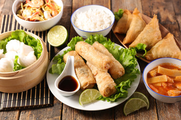 assorted of asian dishes- spring roll, chinese soup, rice and fried noodles