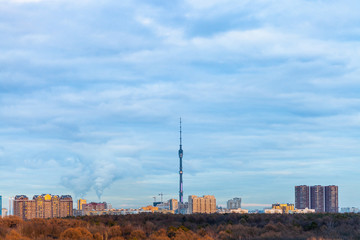 Obraz premium apartment houses and tower under blue cloudy sky