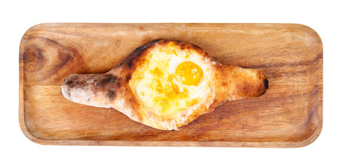 Adjarian khachapuri with egg yolk on tray isolated