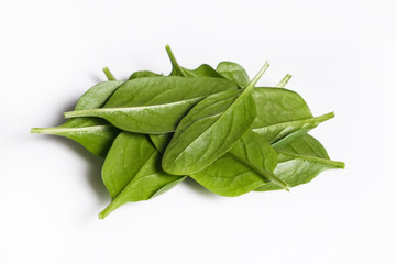 Clean eating concept. Heap of ripe juicy freshly picked organic baby spinach greens isolated on white background. Healthy diet for spring summer detox. Vegan raw food. Close up.