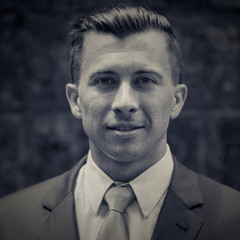 Face of young businessman in suit with vintage filter in black and white