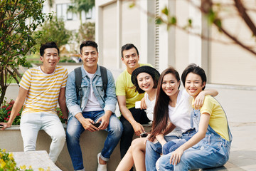 Happy Vietnamese young people spending time together outdoors