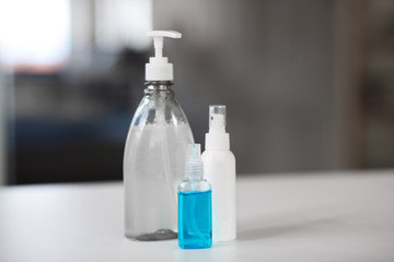 hygiene and disinfection concept - close up of different hand sanitizers on table