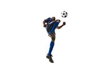Football or soccer player on white background with grass. Young male sportive model training,...