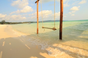 Makeshift swing on the shore of Sok San Beach in Koh Rong Island in Cambodia which is a famous tropical summer travel destination